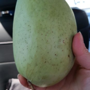 My Tho Supermarket - a hand holding a mango - International Grocery Near Me - Vancouver, British Columbia