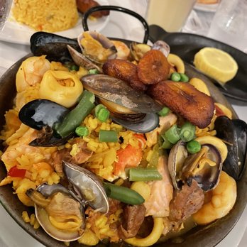 Coco Palm Restaurant - PAELLA VALENCIANA saffron rice simmered with chicken. pork chorizo. fresh fish, scallops, squid, clams, mussels, crab, shrimp - Cuban Near Me - Pomona, California