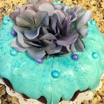 Frosting on Top - a cake with blue icing and purple flowers - Cupcakes Near Me