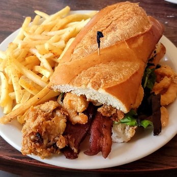 The Hummingbird - Peacekeerp Po'boy. Fried oysters on one side and fried shrimp on the other. With bacon in between. - Breakfast & Brunch Near Me - Fairfax, California The Hummingbird - Peacekeerp Po'boy. Fried oysters on one side and fried shrimp on the other. With bacon in between. - Breakfast & Brunch Near Me - Fairfax, California