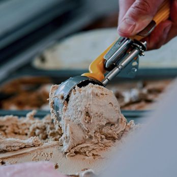 Bow Tie Pizza - a person scooping a scoop of ice cream - Pizza Near Me - Calgary, Alberta Bow Tie Pizza - a person scooping a scoop of ice cream - Pizza Near Me - Calgary, Alberta