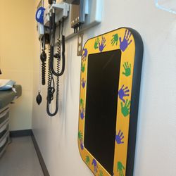 Optum - Mill Creek - Exam room 10 with a thermal drawing pad and ear/nose/throat/blood pressure tools