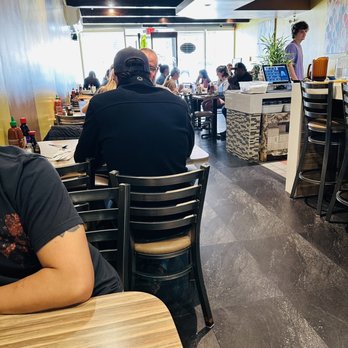 Pho Tran88 - a man sitting at a table in a restaurant - Vietnamese Near Me - San Marcos, Texas