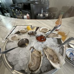 Chef's choice oyster selection, from sweet to salty moving clockwise from the lemon wedges at the top of the bowl. Chef's choice oyster selection, from sweet to salty moving clockwise from the lemon wedges at the top of the bowl.