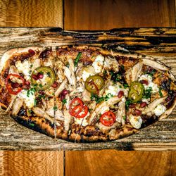 Ripplewood Whiskey & Craft - BBQ Rabbit Flatbread: pomegranate, goat cheese, pickled jalapeño. $15.00