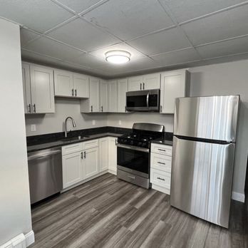 Mister Granite - a kitchen with stainless steel appliances - Countertop Installation Near Me - Newton, Massachusetts