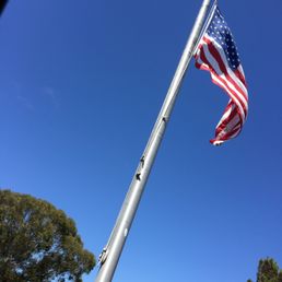 an american flag flying in the wind an american flag flying in the wind