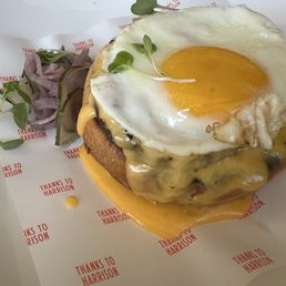 Beef patty on bun with cheddar cream sauce Beef patty on bun with cheddar cream sauce