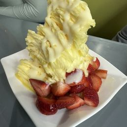 Mango shaved ice with condensed milk and strawberries