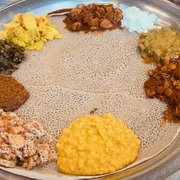 Photo of Zeni Ethiopian Restaurant - San Jose, CA, United States. Shared combo - left side vegetarian n right half chicken n lamb