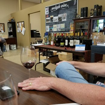 Westgate Wine Store - a man sitting at a bar with a glass of wine - Beer, Wine & Spirits Near Me - Raleigh, North Carolina