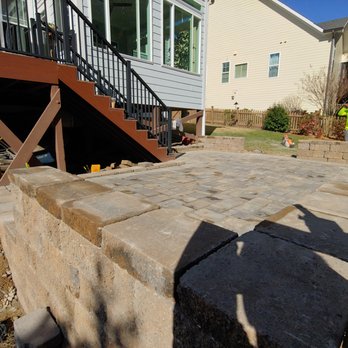 Grand Design - a man standing on a block of concrete - Landscaping Near Me - Raleigh, North Carolina Grand Design - a man standing on a block of concrete - Landscaping Near Me - Raleigh, North Carolina