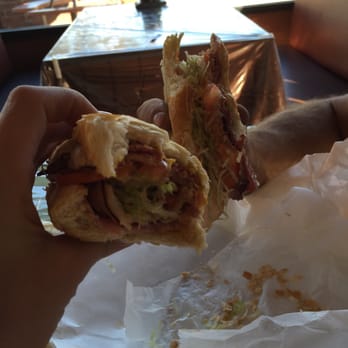Hickory Baked Ham Company - a hand holding a half eaten sandwich - Meat Shops Near Me - Wheat Ridge, Colorado Hickory Baked Ham Company - a hand holding a half eaten sandwich - Meat Shops Near Me - Wheat Ridge, Colorado