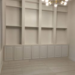Cam Remodeling - "A custom wall unit, built-in and sleek, finished in crisp white for a clean, modern look that seamlessly blends with the room."