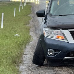 Country Hills Nissan - The side of the road on Highway 2/Deerfoot, where the many bolts holding the tire on all snapped from the vibrations from a bad alignment.