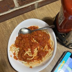 Grotto Pizza - Newark - Pasta & Meatballs kids portion. Meatball already cut up on the little girls plate.