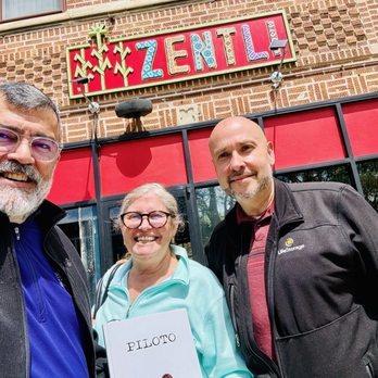 Zentli - At front of restaurant with Artist-Chef Piloto' book - Mexican Near Me - Evanston, Illinois