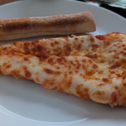 Cheese pizza slice and breadstick
