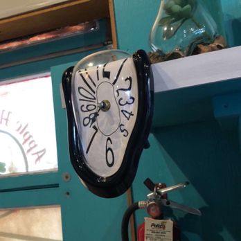 Java Station - a clock on a shelf above a fire extinguisor - Coffee & Tea Near Me - Wenatchee, Washington