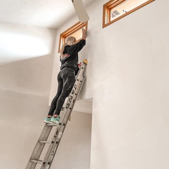 RL Drywall & Insulation -  a woman on a ladder - Drywall Installation & Repair Near Me - Sioux Falls, South Dakota