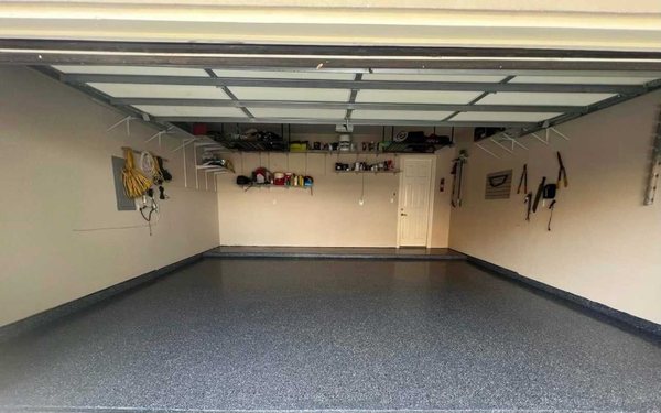 Garage Revamp: Epoxy Floor Installation - This project transformed a standard garage into a clean, durable, and visually appealing space with a professionally installed epoxy floor. The team prepped the concrete surface meticulously before applying a high-performance epoxy coating, resulting in a glossy, easy-to-clean finish that resists stains, chemicals, and wear. The upgraded floor adds both value and style, making the garage a standout feature of the home.