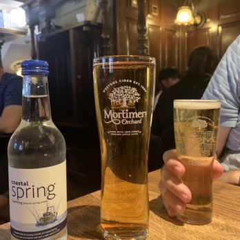 St Stephen's Tavern - Sparkling water, pint of Mortimer's Orchard hard cider, hall pint of lager - Fish & Chips Near Me - London, XGL St Stephen's Tavern - Sparkling water, pint of Mortimer's Orchard hard cider, hall pint of lager - Fish & Chips Near Me - London, XGL