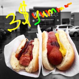 two hotdogs with mustard and ketchup two hotdogs with mustard and ketchup
