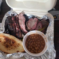 Mike's Backyard BBQ - Rib/tri-tip platter. Includes garlic bread, pickle and baked beans.