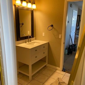 RHS Construction - a bathroom with a sink and mirror - General Contractors Near Me