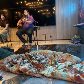 Mellow Mushroom St. Augustine - Murabella - a pizza on a table - Pizza Near Me - St. Augustine, Florida Mellow Mushroom St. Augustine - Murabella - a pizza on a table - Pizza Near Me - St. Augustine, Florida