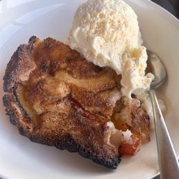 Fresh peach cobbler and ice cream.