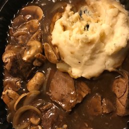 a plate of meat, mashed potatoes and mushrooms a plate of meat, mashed potatoes and mushrooms