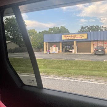 Quenching Caverns - a car parked in front of a convenience store - Beer, Wine & Spirits Near Me - Columbus, Ohio