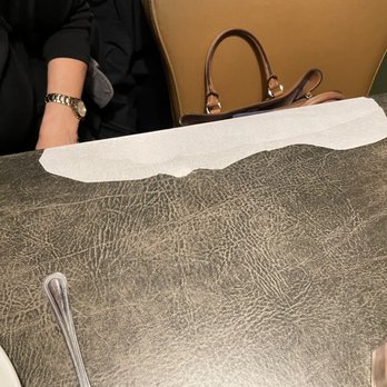 Ruby Tuesday - Deteriorated and peeling vinyl tablecloth at our table - American Near Me - Gettysburg, Pennsylvania