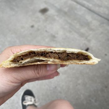Capital B Cafe - a hand holding a half eaten sandwich - Cafes Near Me - Mississauga, Ontario