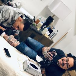 Zebra Tattoo & Body Piercing - Stef Curry tattooing our artist, Nino Lapid :)