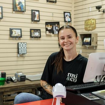 Your Pet Stop - Zoe at the Roxi & Co checkout counter helping customers and their pets in our Sioux Falls pet store. - Pet Stores Near Me - Sioux Falls, South Dakota