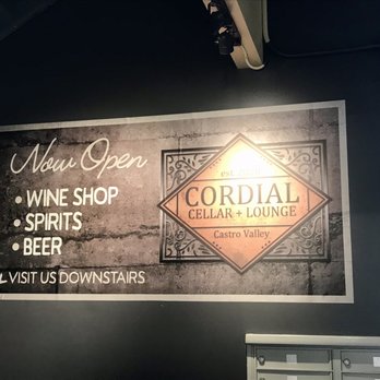 Cordial Cellar + Lounge - A sign near the elevator and stairs on the second floor of the Castro Valley Marketplace - Wine Bars Near Me - Castro Valley, California