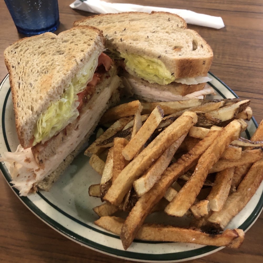 Buffalo Chicken Club Sandwich with a side of hand cut fries. Buffalo Chicken Club Sandwich with a side of hand cut fries.