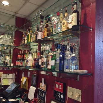 Black Dog Pub - shelves of liquor and liquor glasses - Salad Near Me Black Dog Pub - shelves of liquor and liquor glasses - Salad Near Me