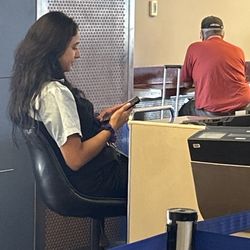 United Airlines - Too busy on her phone! Sarcastic and belittling!