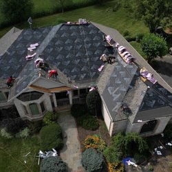 Moonshot Roofing - Moonshot Roofing crew completing a residential roof replacement with new underlayment and shingles being installed.