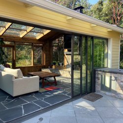 Seattle Patio Covers - Wood sunroom with retractable glass walls.