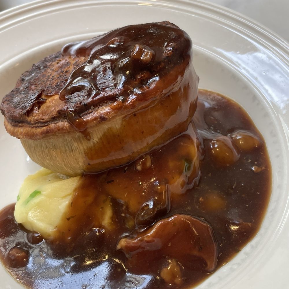 Mother Mash - Champ mash, steak and blackheart stout pie w/traditional gravy. - British Near Me - London, XGL Mother Mash - Champ mash, steak and blackheart stout pie w/traditional gravy. - British Near Me - London, XGL