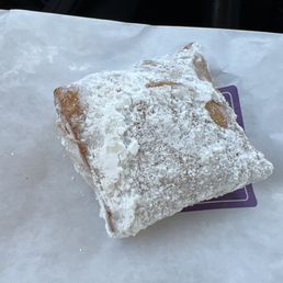 a powdered pastry on a napkin
