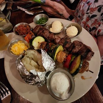 Black Bart's Steakhouse - Steak kabobs, vegetables kabobs, bake potato with butter, sour cream, bacon and cheese with a salad - Steakhouses Near Me - Flagstaff, Arizona