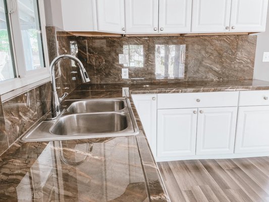 Kitchen Remodel - This remodel was done on an old kitchen that was in bad shape. We gutted it and refinished the cabinets to match the overall tone of the house.