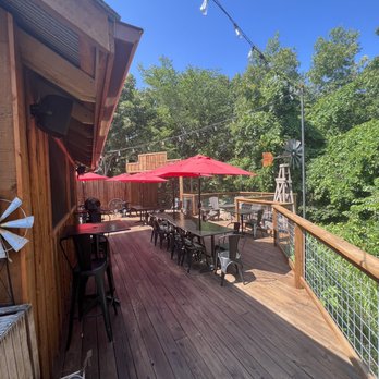 Old 76 Smokehouse - deck with tables and umbrellas - Barbeque Near Me - Branson, Missouri