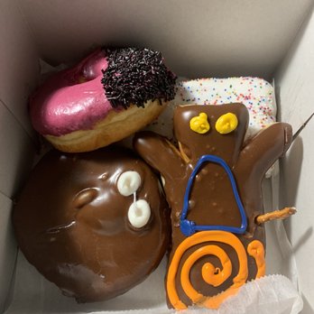 Voodoo Doughnut - Portland Cream, Viscous Hibiscus, Voodoo Doll, and Strawberry Go-Tart - Donuts Near Me - Portland, Oregon Voodoo Doughnut - Portland Cream, Viscous Hibiscus, Voodoo Doll, and Strawberry Go-Tart - Donuts Near Me - Portland, Oregon