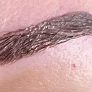 Luminous Beauty - Close-up of left/high brow: bottom of stencil was aligned just above natural brow line at arch, accentuating height - Waxing Near Me - Tehachapi, California